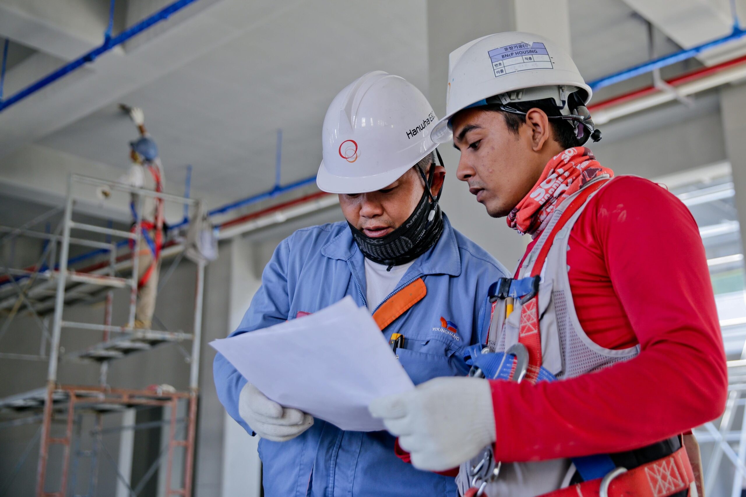 Albuquerque construction workers reading blueprints.