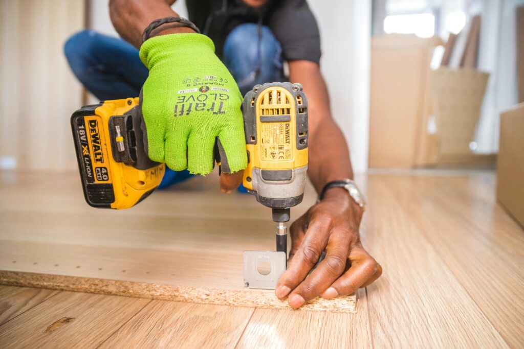 Construction worker assembling cabinets.